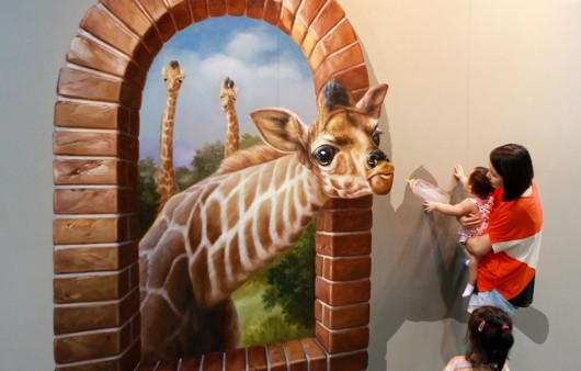 People interacting with 3D  paintings at the Magic Art 